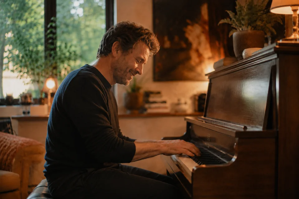 A pianist at the keys, arranging a song by ear